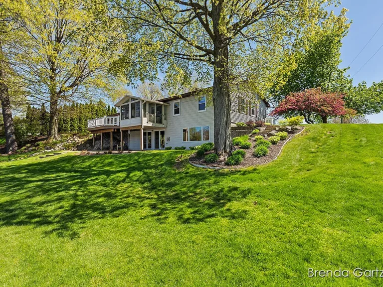 This exquisite executive ranch boasts over 240 feet of private lake frontage on a serene 5-acre lake